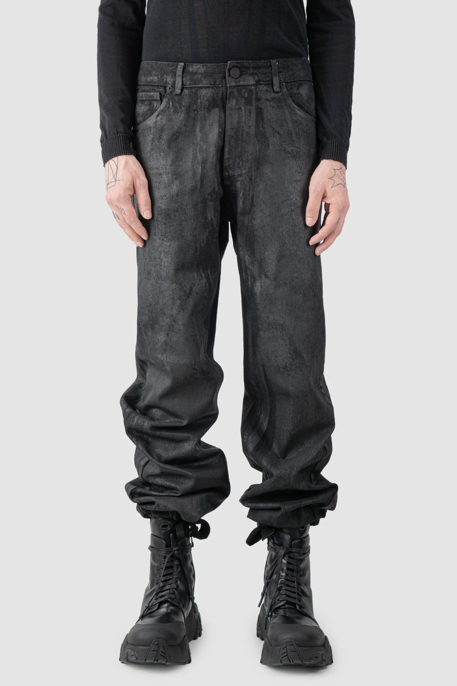 La Haine Inside Us - model front wrapped hem of men’s Black Hand-Painted Rubberized Coated Denim Jeans