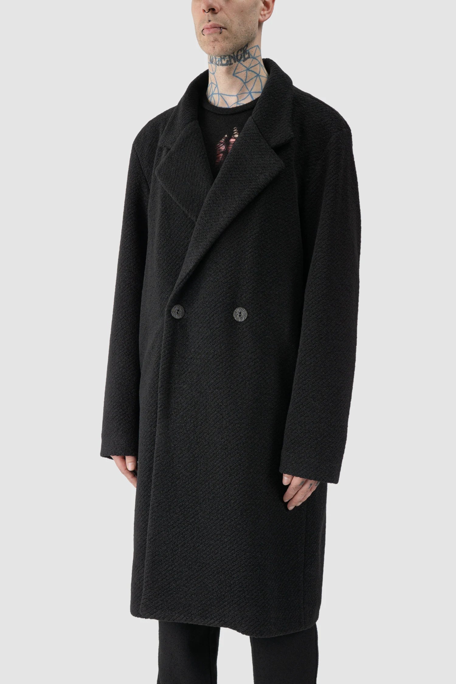 La Haine Inside Us - model side view of men’s FW25 Black Long Wool Blend Coat with 2-Button Closure
