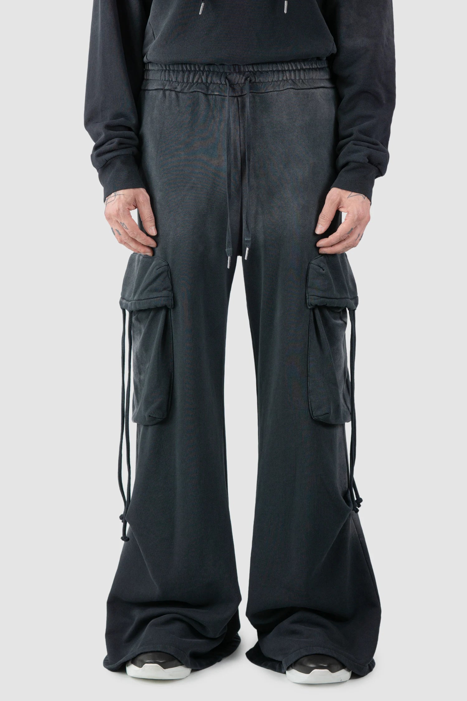 La Haine Inside Us - model front view of men’s FW25 Grey Sprayed Cotton Wide Leg Cargo Jogger Pants