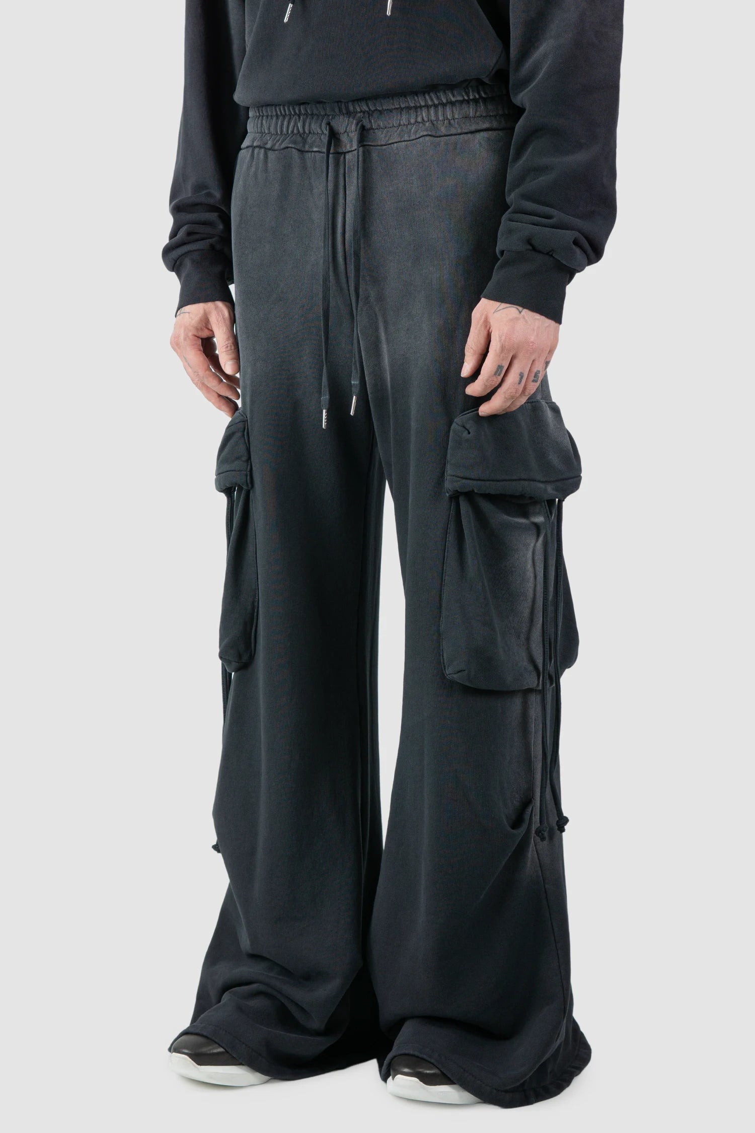 La Haine Inside Us - model side view of men’s FW25 Grey Sprayed Cotton Wide Leg Cargo Jogger Pants