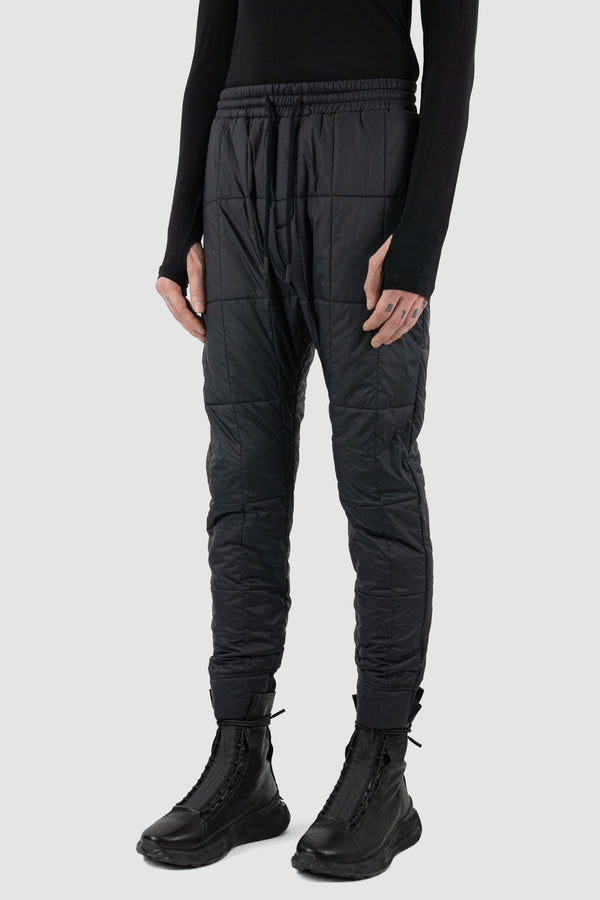 Black Quilted Slim Pants for Men - NOMEN NESCIO FW23 Collection. Made from 100% Recycled Polyamide with Merino Wool Detail. Slim & Straight Cut, Elastic Waistband. Made in Estonia.