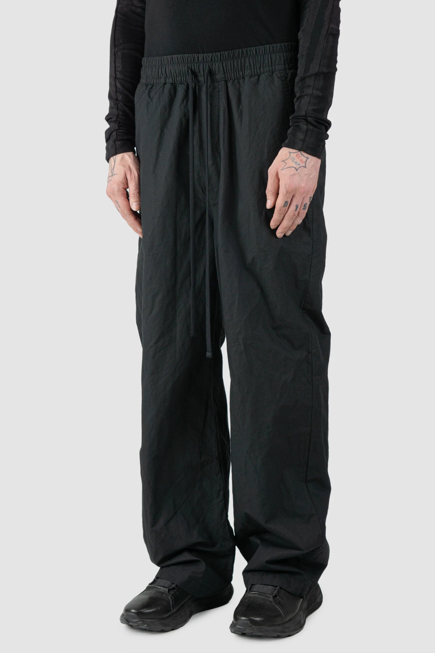 Thom Krom - model side view of men’s FW25 Black Metallic Wide Leg Cotton Trousers - M-P-19