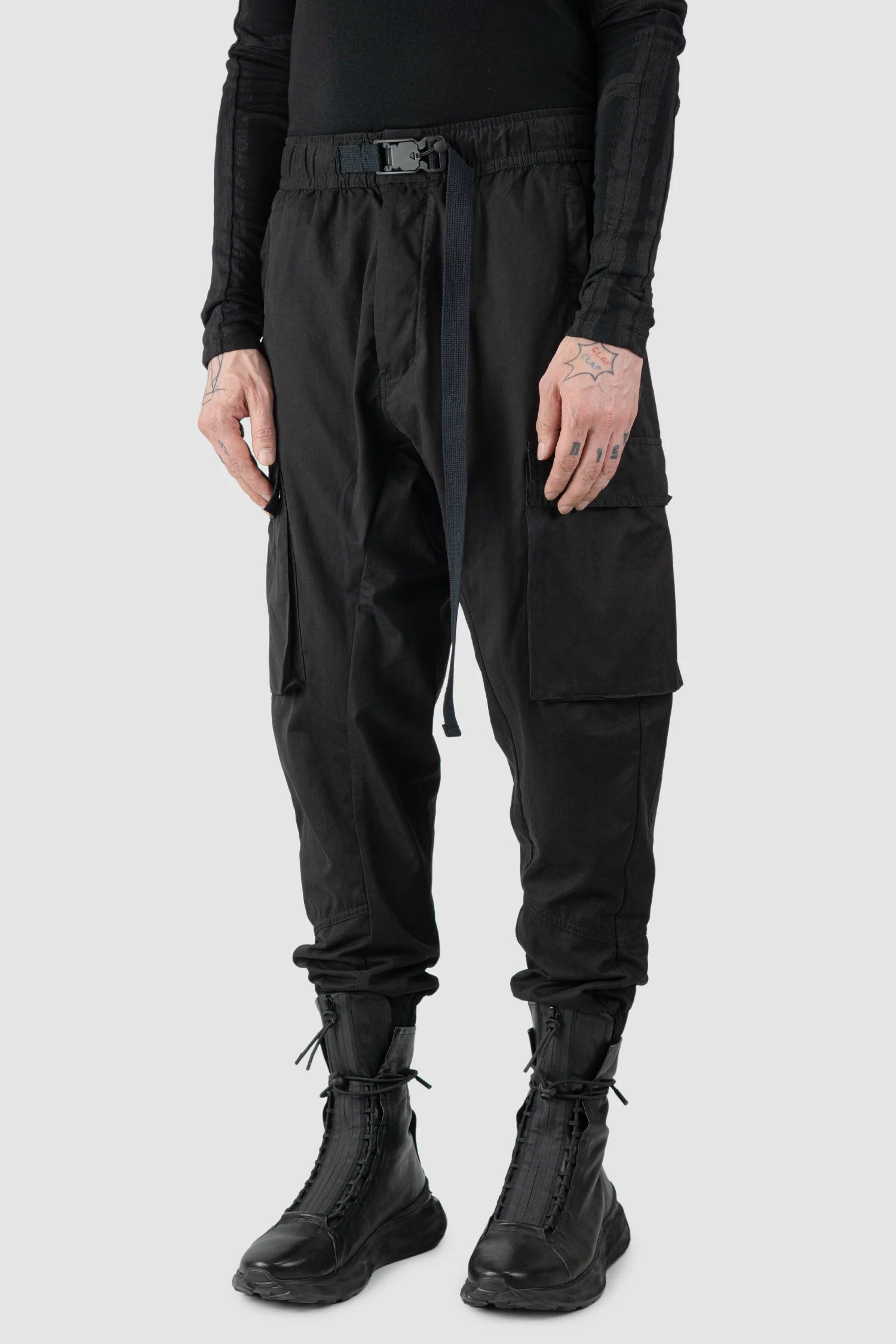 Thom Krom - model side view of men’s FW25 Black Peached Cotton Cargo Trousers with Magnetic Belt - M-P-15