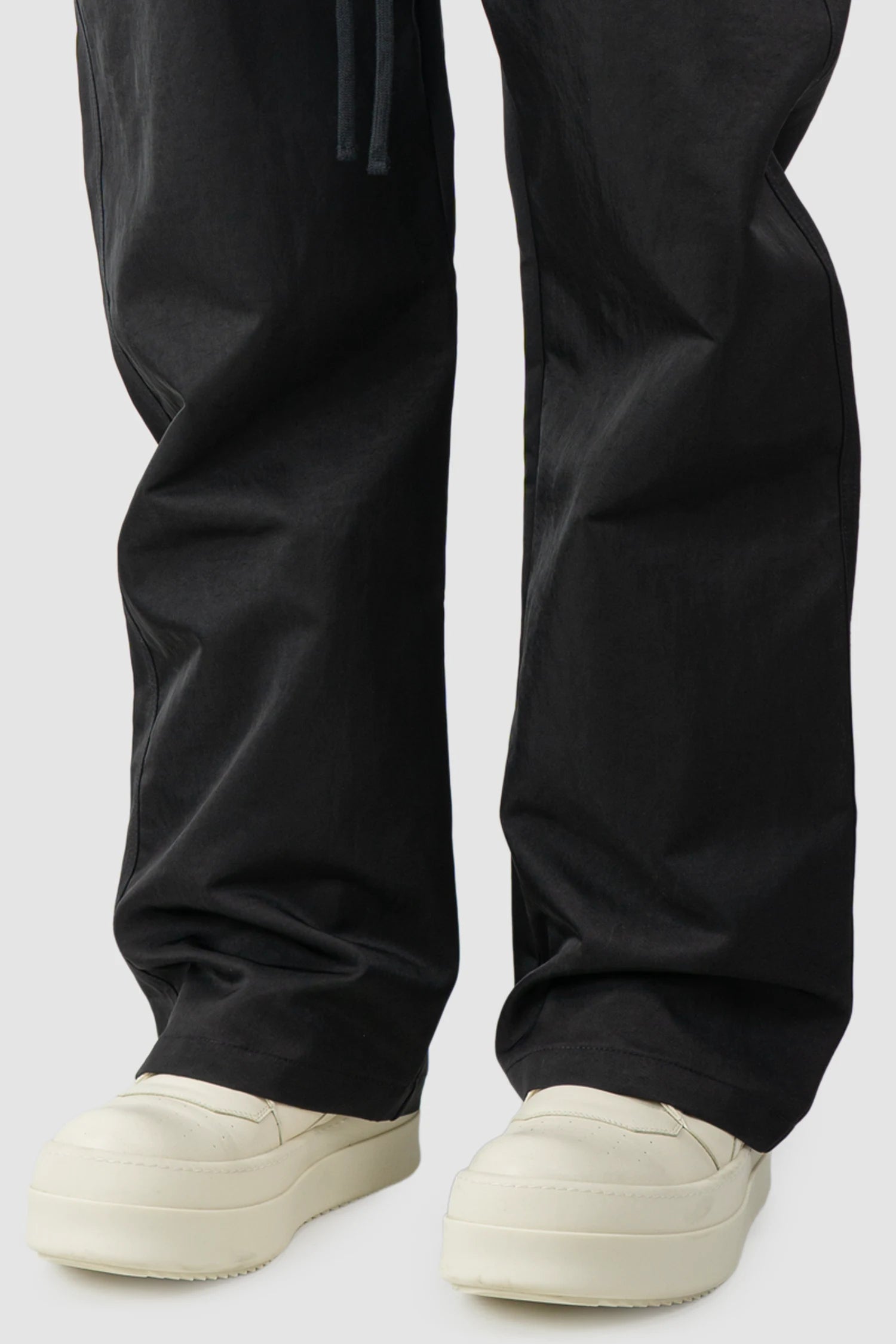 Thom Krom – Men's Black Tech Woven Wide Leg Trousers - hem detail view